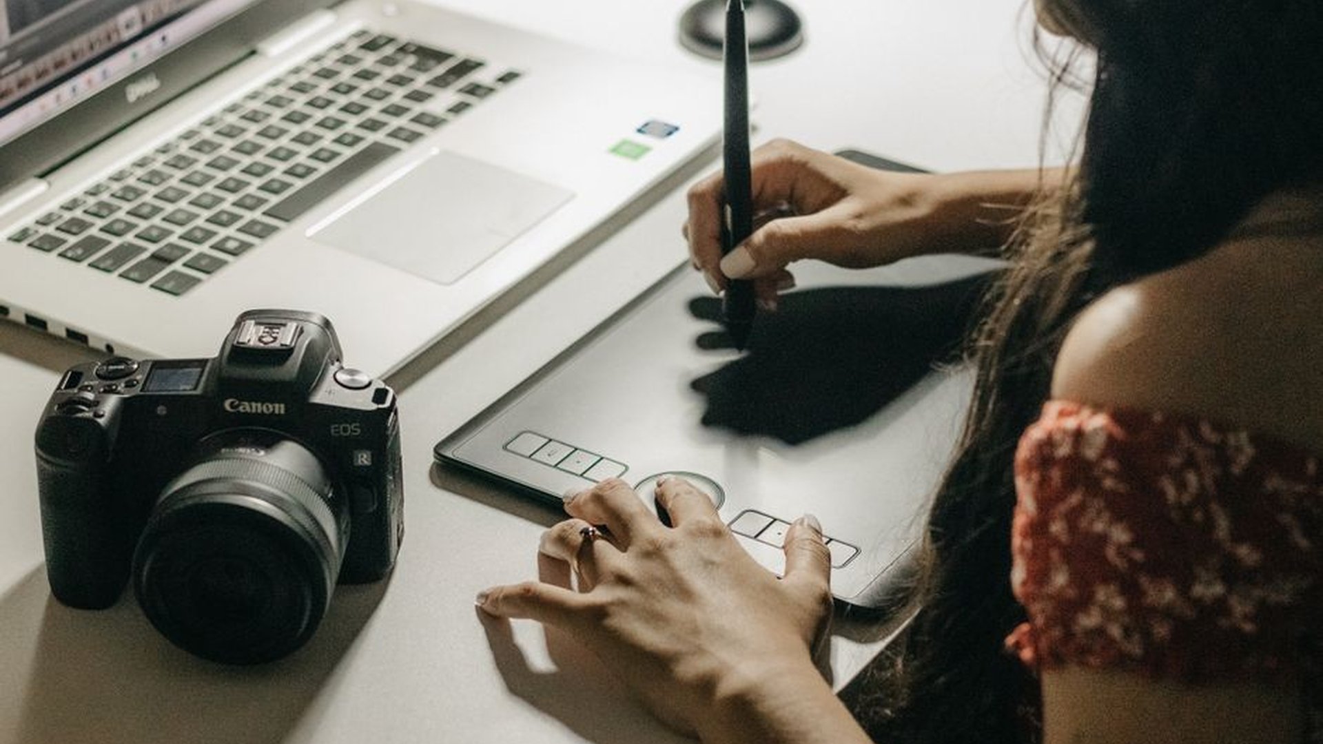 graphic designer working on laptop with client fee